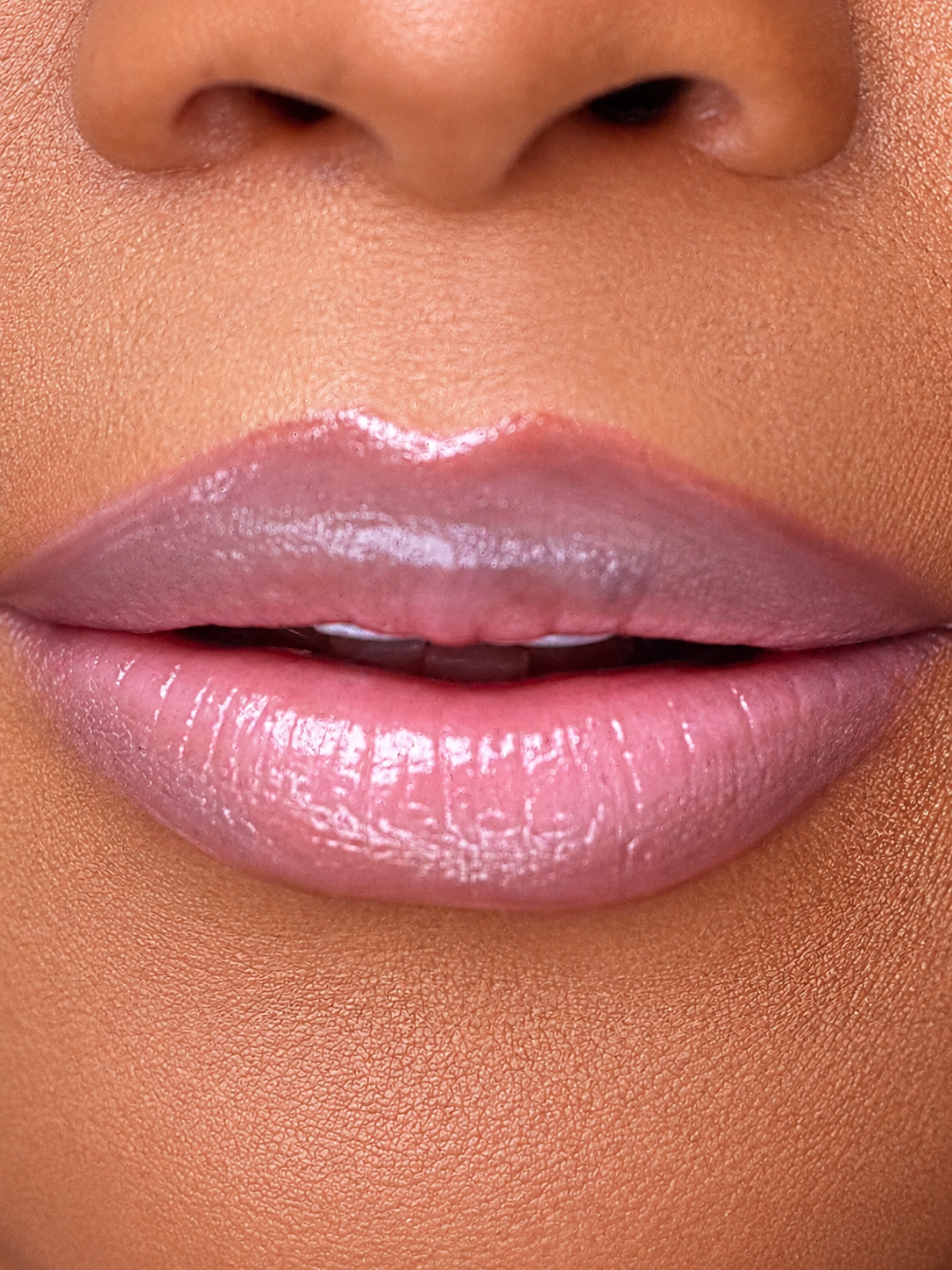 Close-up of glossy soft pink ombré lips with deeper edges and a lighter pink center | Glam N' Go Style