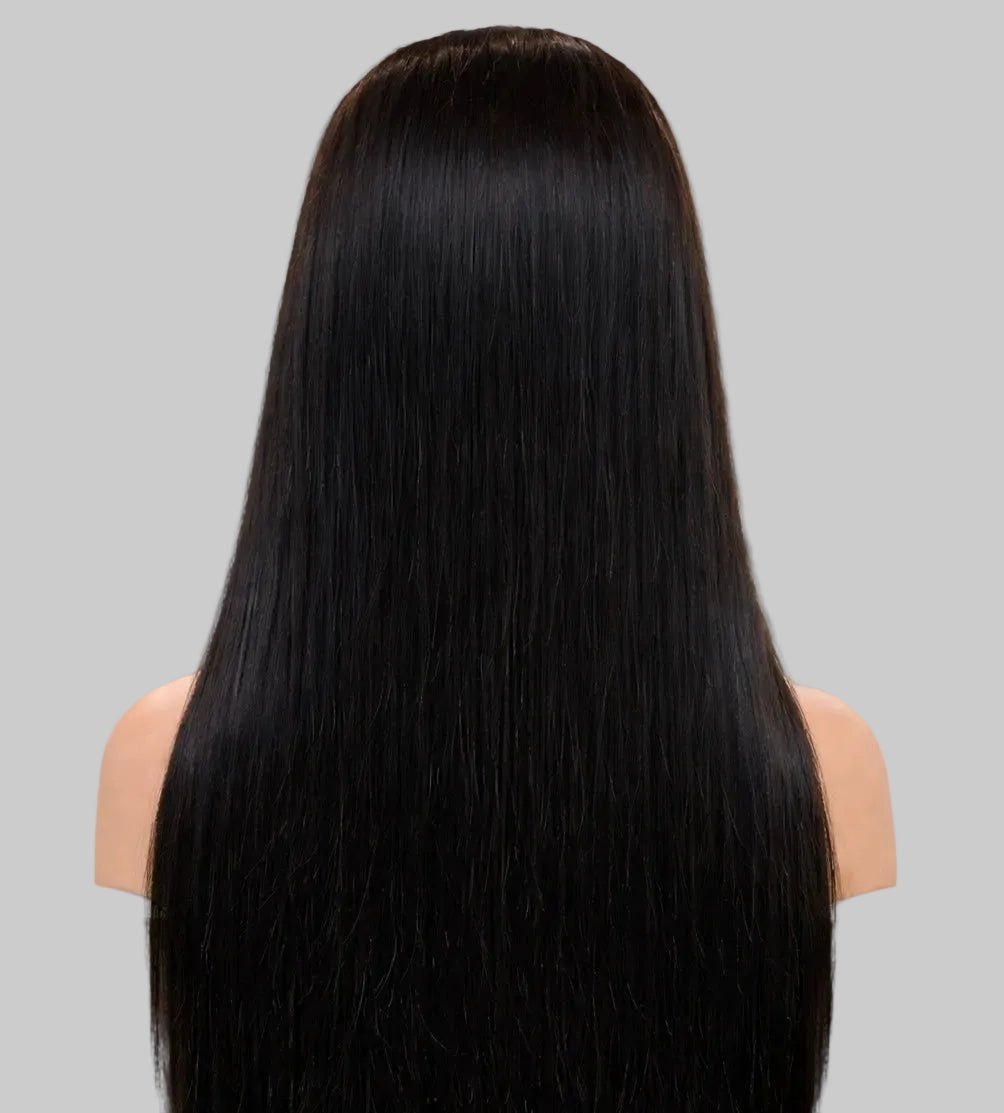 Person with long, straight black hair in a kitchen setting