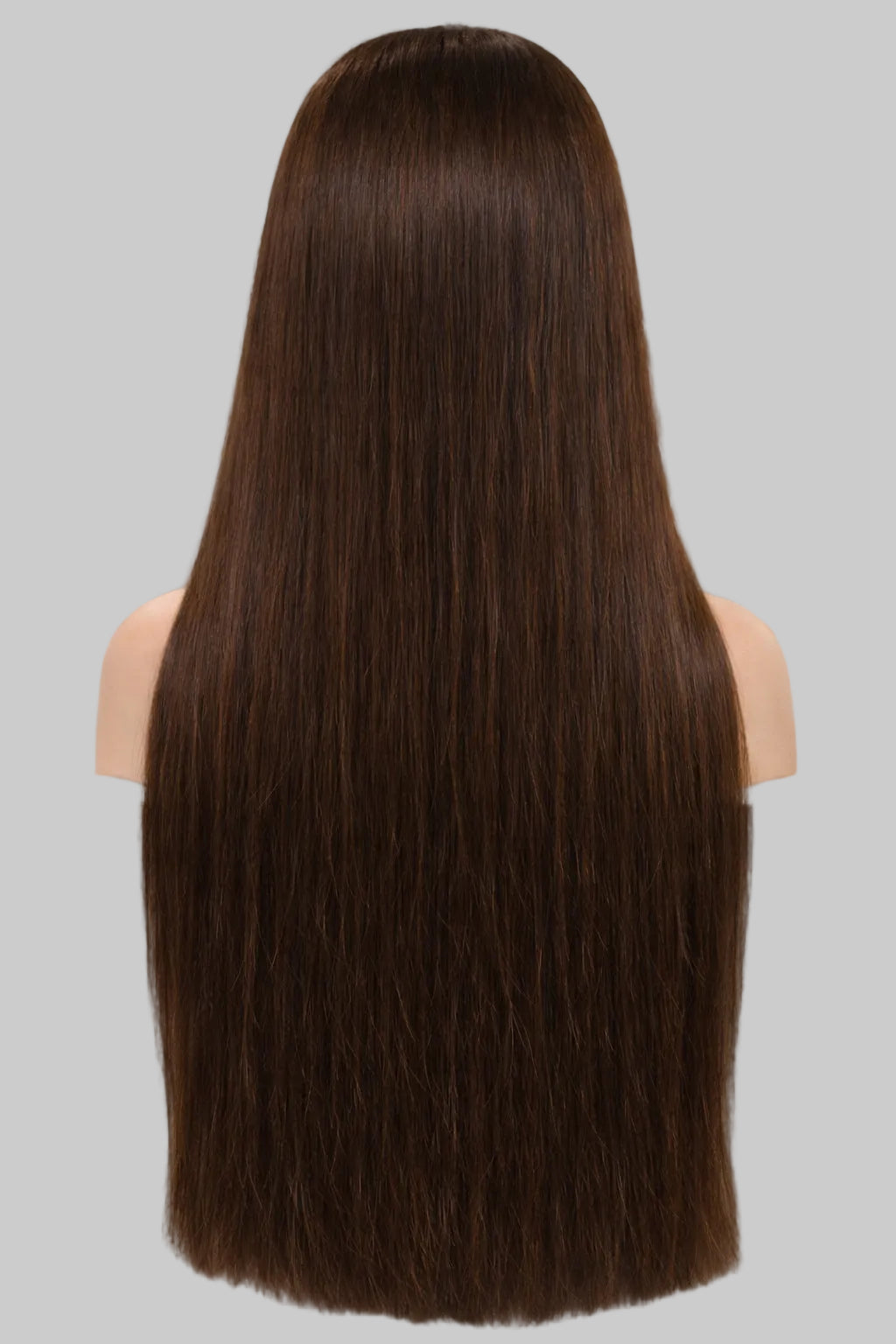 Person with long, straight brown hair in a salon setting