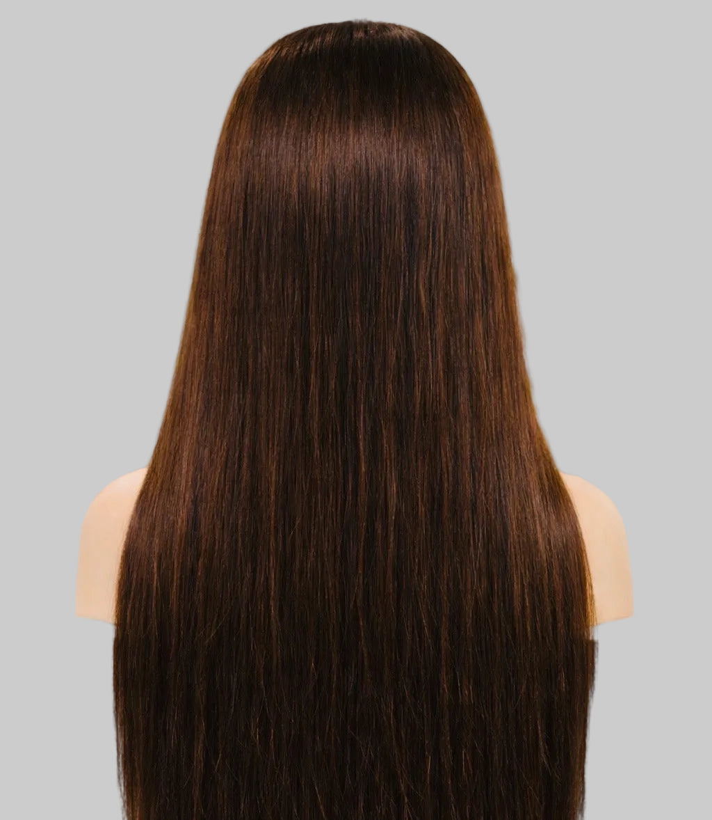 Person with long, straight brown hair in a kitchen setting