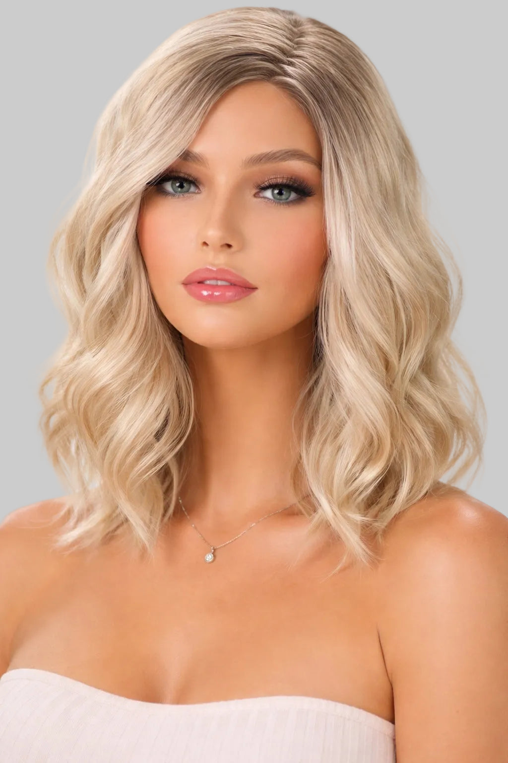 Woman with styled blonde hair against a plain background