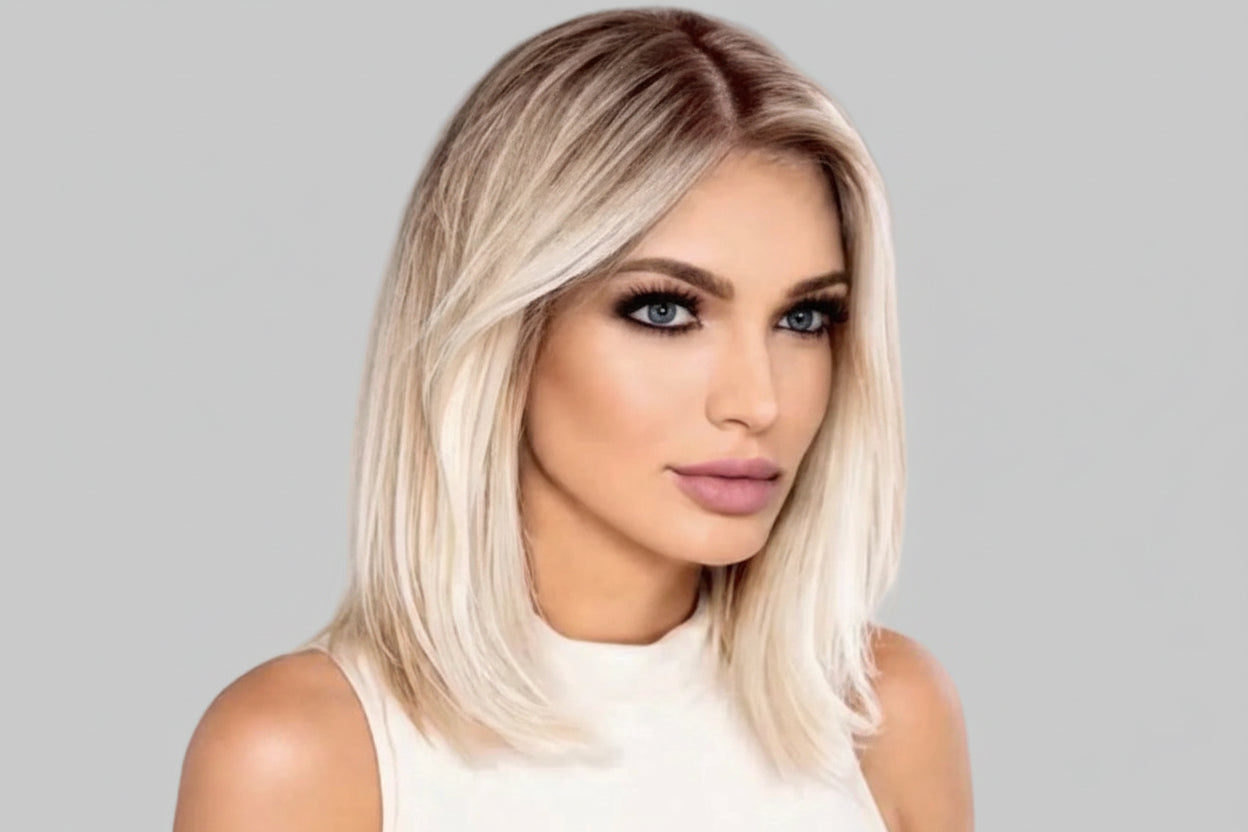 Woman with blonde hair and a white top against a light gray background